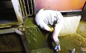 Horny guy dives into cow shit and strokes his cock with a naughty girl’s help